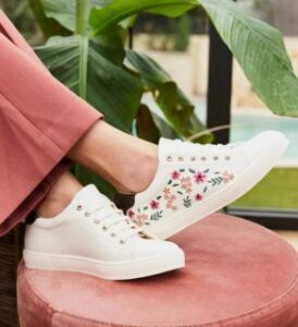 Virevolte Recycled Grain Leather Embroidered Vegan Sneakers | Primro worn by a woman with rose pastel pants