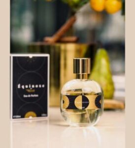 glass flask of vegan fragrance equinox from minuit sur terre next to it's box presented by veganlyy.com