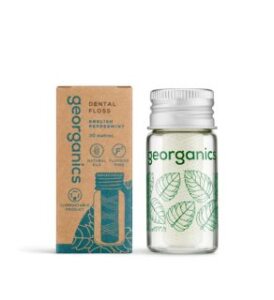 mini jar of vegan plastic free English peppermint dental floss next to its box by georganics and veganlyy