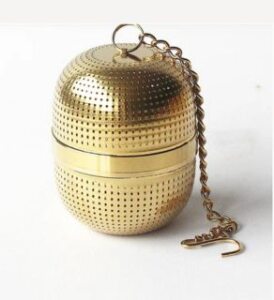 perforate goolden soak sphere laying on white table presented by veganlyy.com