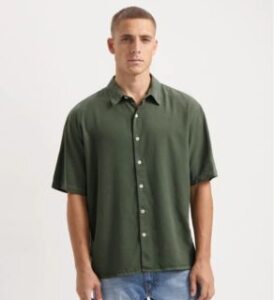 man with green TENCELL casual shirt on beige background by veganlyy.com