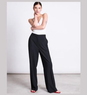 young woman wearing jan'n june wide pants corallie black presented by veganlyy women's vegan clothes