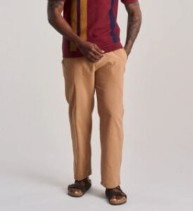 a black man wearing komodo Tan color Joshua organic cotton trousers presented by veganlyy.com