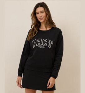 a young woman wearing veganlyy pact apparel's cloud brushed fleece graphic crew sweatshirt