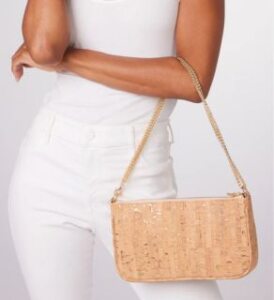 veganlyy presents svala vegan handbag with gold speckled strap worn by a tanned model